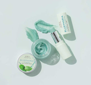 Cosmetic products with green and white packaging on a light gray background