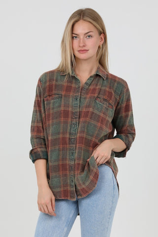 Woman wearing a plaid shirt and light blue jeans on a white background