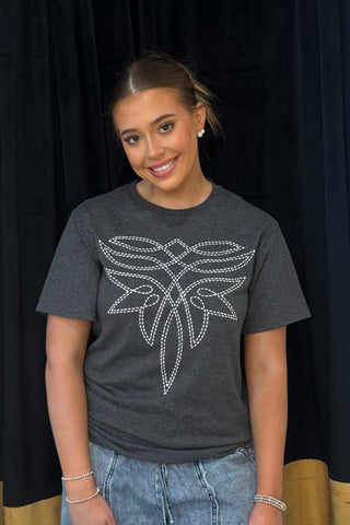 Person wearing a dark gray t-shirt with a white feather design against a black background