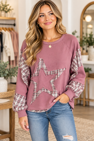 women wearing outfit standing in a boutique.