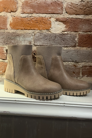 Boots in front of a brick wall 