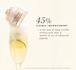 A cosmetic jar labeled 'Lift Champagne Moon Dew' shown tilted over a champagne flute with lemon slices, on a warm cream background with text reading '45% Visible Improvement' and a small testing note at the bottom.