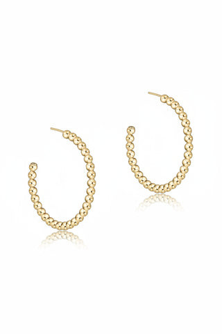 Gold hoop earring with beaded design on a white background
