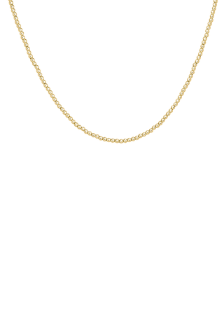 Gold beaded necklace on a white background