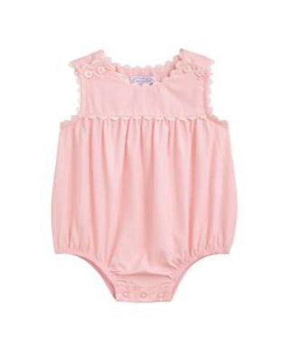 Pink baby romper with ruffled details on a white background
