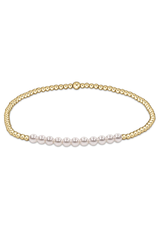 Gold and pearl bracelet on a white background
