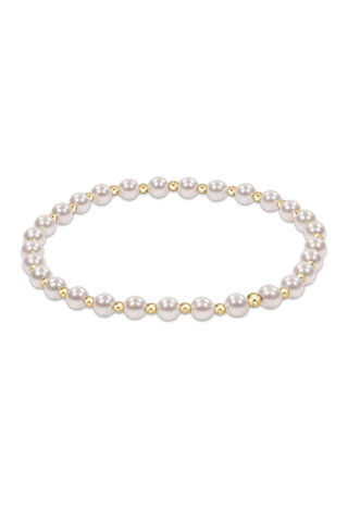 Pearl bracelet with gold accents on a white background