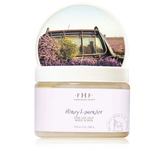 Jar of Farmhouse Fresh Honey Lavender body scrub with a scenic bottle cap.