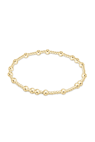 Gold beaded bracelet on a white background