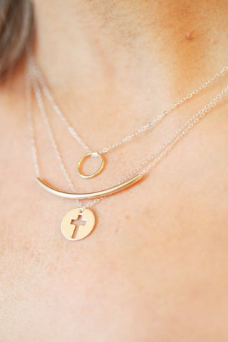 Necklace with gold pendant on a person's neck