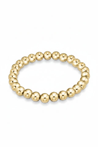 gold bead bracelet on white background