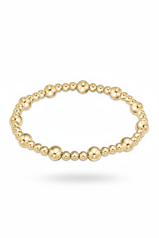 Gold beaded bracelet on a white background