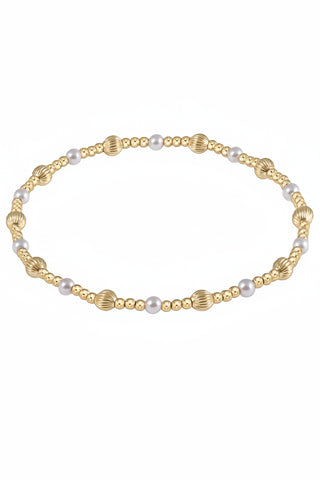 Gold and pearl bracelet on a white background