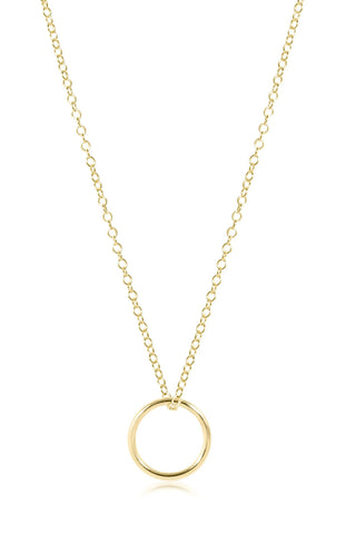 Gold necklace with a simple ring pendant on a white background
