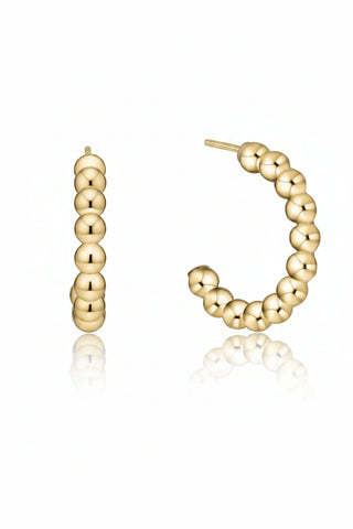 Gold hoop earrings with beaded design on a white background