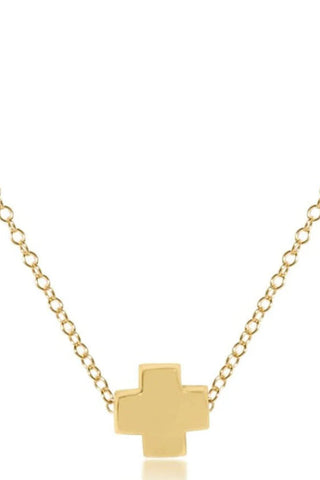 Gold cross necklace on a white background