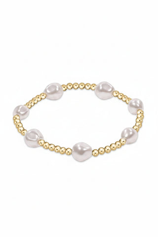 Pearl and gold beaded bracelet on a white background