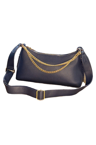 Blue handbag with gold chain strap on a wooden surface