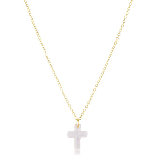 Gold necklace with a white cross pendant on a white background
