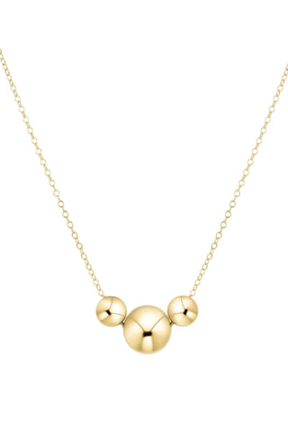 Gold necklace with three round pendants on a white background