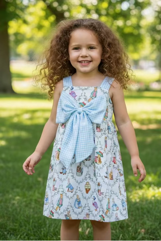 Pinafore dress with a large bow on a mannequin against a plain background
