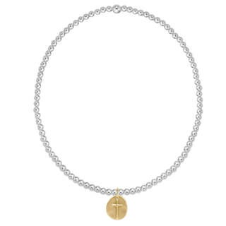 Pearl necklace with a gold cross pendant on a white background