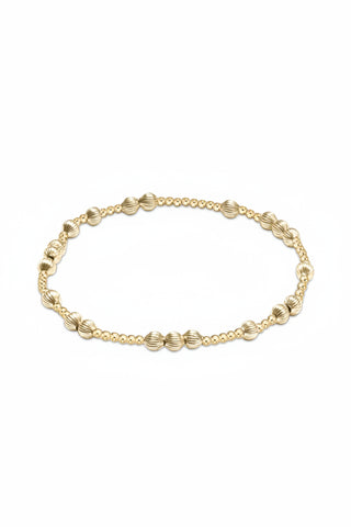 Gold beaded necklace on a white background