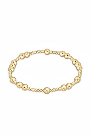 Gold beaded bracelet on a white background