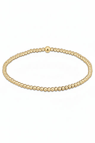 Gold beaded bracelet on a white background