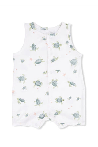 White romper with turtle pattern on a white background