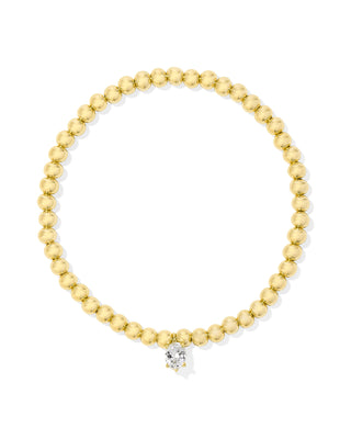 Gold beaded bracelet with a diamond on a white background