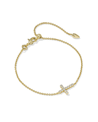 Gold bracelet with a cross and pearl charm on a white background