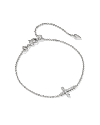 Silver bracelet with a small cross charm on a white background