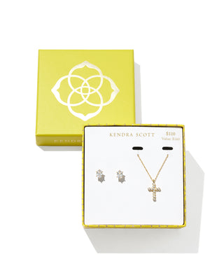 Kendra Scott gold crystal cross necklace and matching crystal stud earrings gift set displayed in a yellow branded gift box, marked $110 with a $140 value.