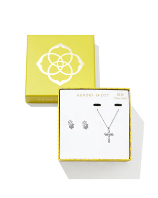 Kendra Scott gold crystal cross necklace and matching crystal stud earrings gift set displayed in a yellow branded gift box, marked $110 with a $140 value.