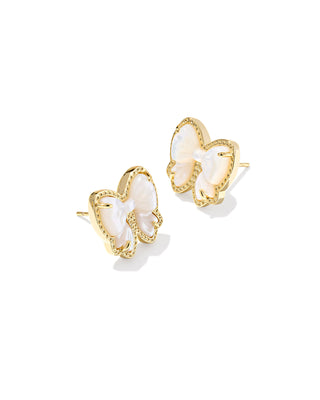 Bow-shaped earrings with gold and white details on a white background