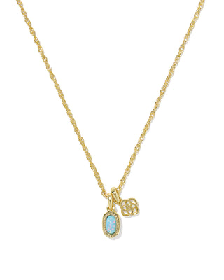 Gold necklace with a blue gemstone pendant on a white background