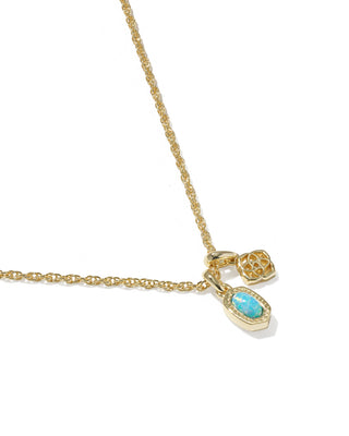 Gold necklace with a turquoise pendant on a white background