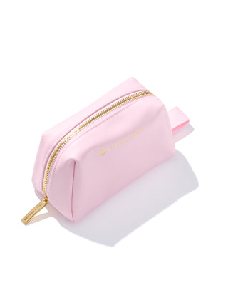 Pink cosmetic bag with gold zipper on a white background