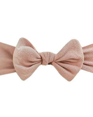 Pink bow headband on a white background