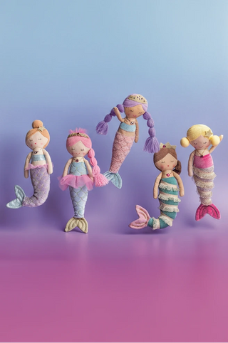 Five colorful mermaid dolls with different hairstyles on a gradient purple background