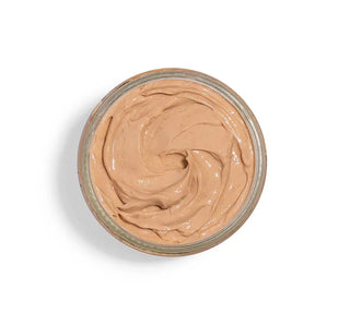 Jar of beige cream with a swirl on a white background