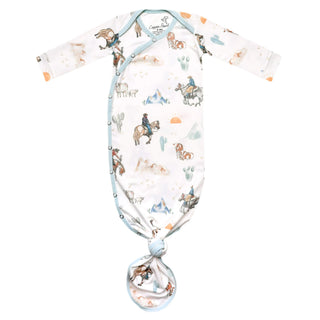 Baby gown with cowboy print on a white background