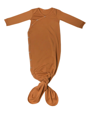Brown baby knotted gown on a white background