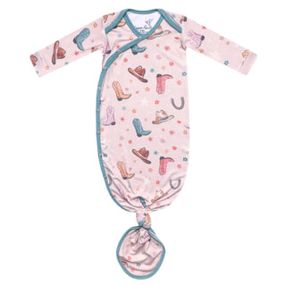 Baby gown with cowboy print on a white background