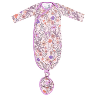 Floral-patterned baby swaddle with a round pendant on a white background