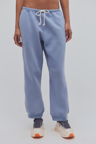 Light blue sweatpants worn by a person on a plain background