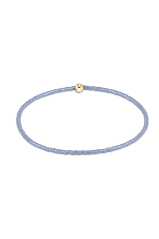 Delicate purple beaded necklace with a gold clasp on a white background