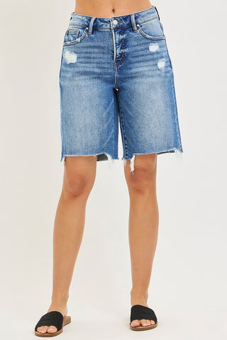 Denim shorts worn by a person on a white background