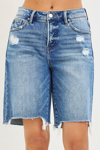 Blue denim shorts with slight distressing on a white background